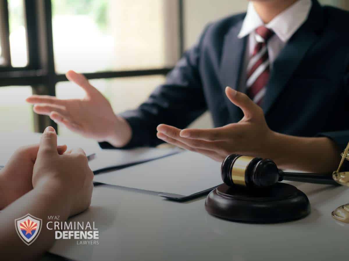 Attorney discussing legal options with a client facing Disorderly Charges, with a gavel on the table