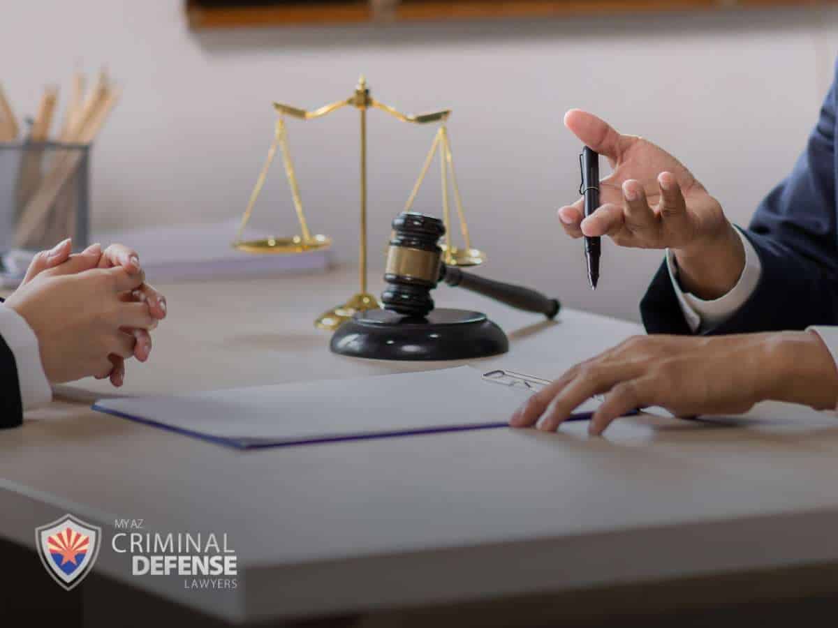 Attorney-client discussion with legal documents, emphasizing confidentiality and attorney-client privilege in criminal defense cases