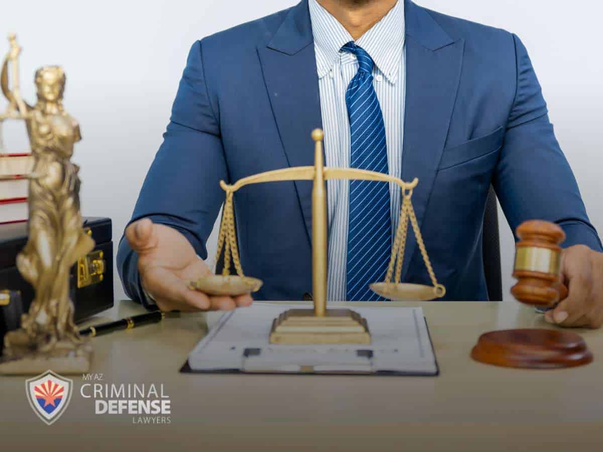 Attorney discussing Criminal Activity with scales of justice and a gavel