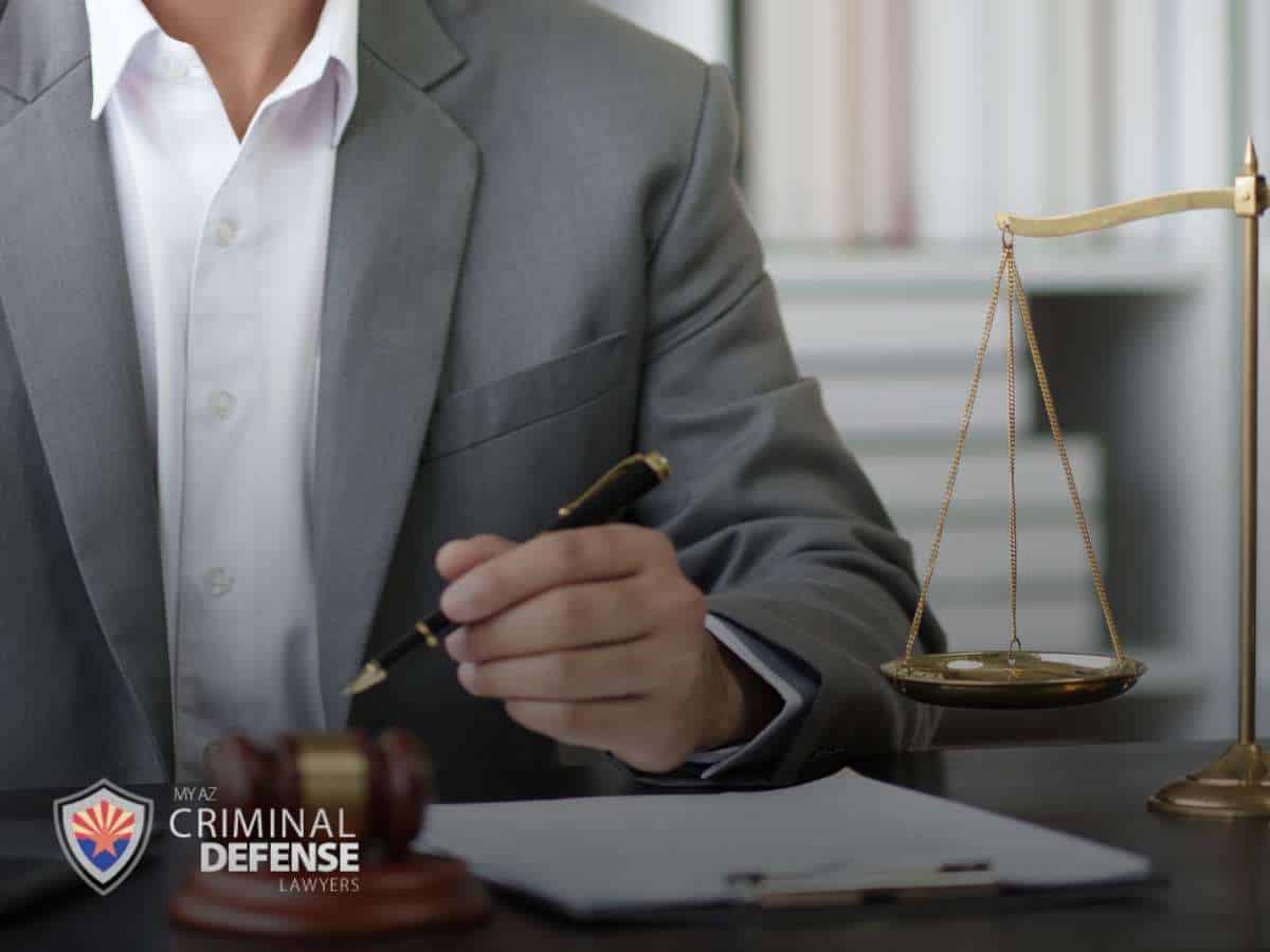 Attorney reviewing documents related to criminal charges in Arizona
